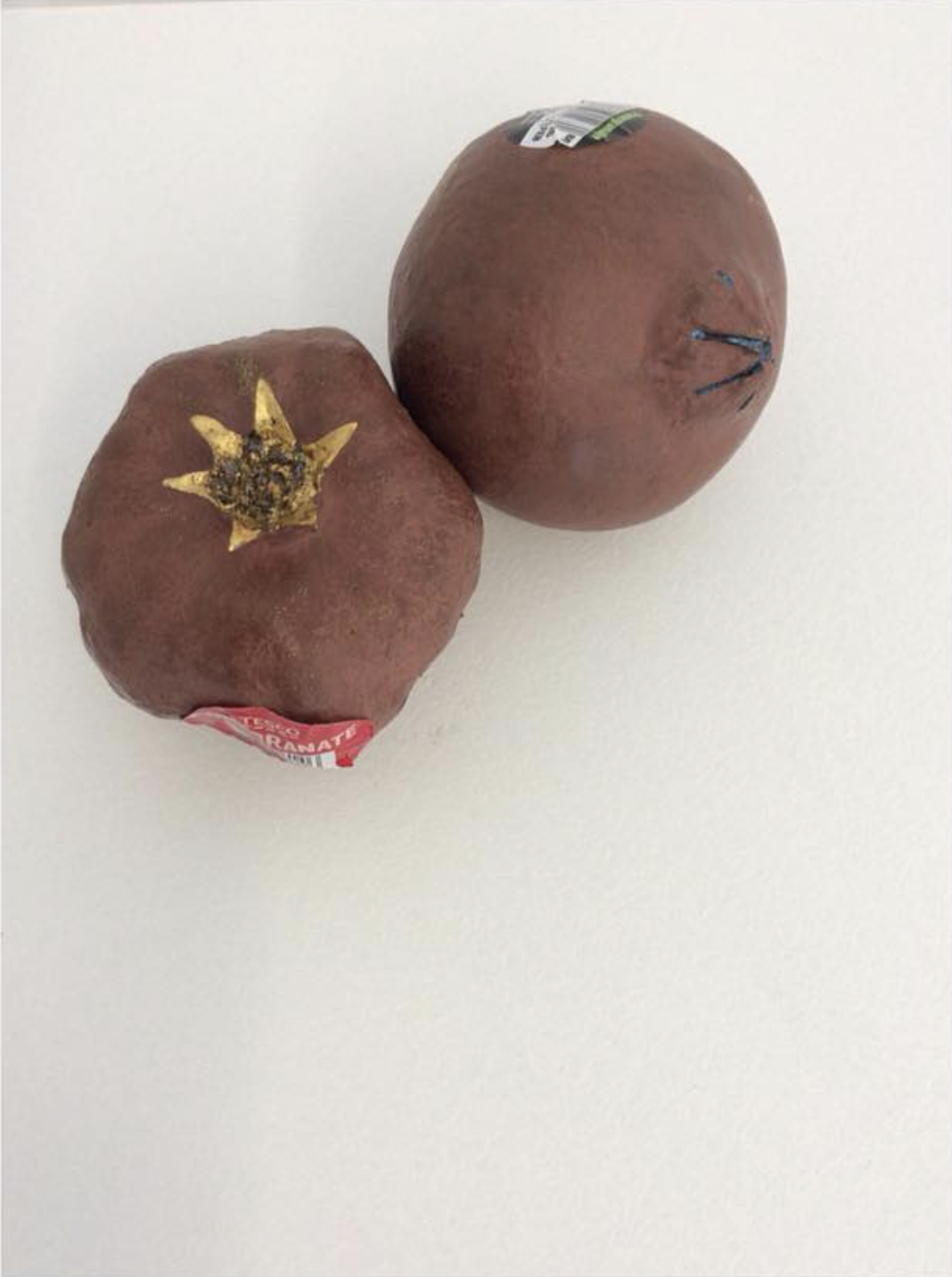 This pair of bronze pomegranates were created by investing two beautiful pomegranates in plaster investments and then burnt out in a kiln, bronze was poured into the cavity left behind in the plaster mould. The process makes each piece individual and creates a permanent memory of the object which was burnt away.